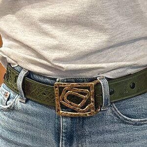 Handmade stamped green leather belt with gold colored buckle.